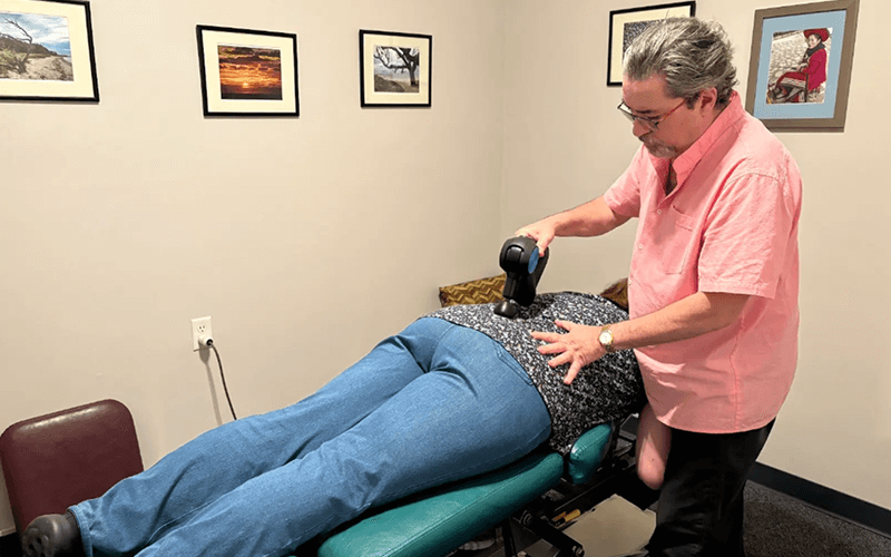 Dr. Sandy treating a patient's back pain